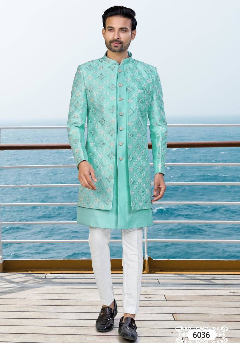 Turquoise sherwani with floral embroidery and white trousers—perfect for weddings.