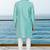 Turquoise sherwani with floral embroidery and white trousers—perfect for weddings.