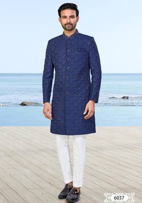 Navy blue sherwani with subtle texture, pocket square, and white trousers—ideal for weddings and formal events. 1