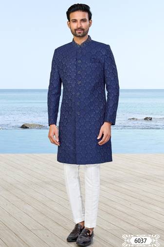 Navy blue sherwani with subtle texture, pocket square, and white trousers   ideal for weddings and formal events.
