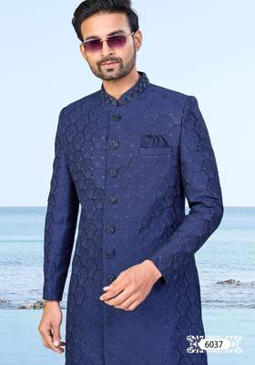Navy blue sherwani with subtle texture, pocket square, and white trousers—ideal for weddings and formal events. 3