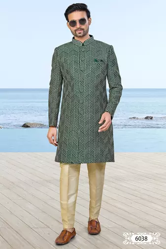 Green sherwani with geometric detailing, a pocket square, and gold-toned trousers—perfect for festive occasions.