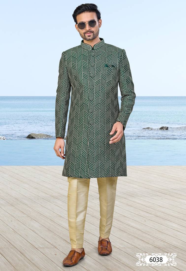 Green sherwani with geometric detailing, a pocket square, and gold-toned trousers—perfect for festive occasions.