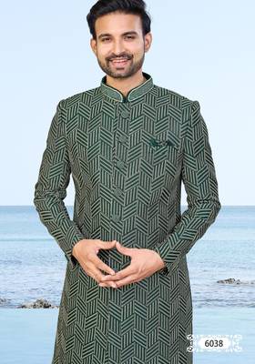 Green sherwani with geometric detailing, a pocket square, and gold-toned trousers—perfect for festive occasions. 3
