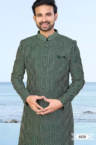 Green sherwani with geometric detailing, a pocket square, and gold-toned trousers—perfect for festive occasions.