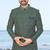 Green sherwani with geometric detailing, a pocket square, and gold-toned trousers—perfect for festive occasions.