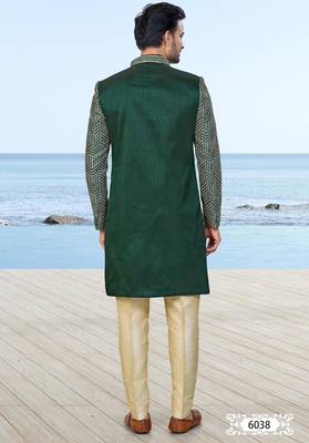 Green sherwani with geometric detailing, a pocket square, and gold-toned trousers—perfect for festive occasions. 4