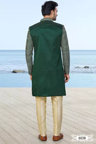 Green sherwani with geometric detailing, a pocket square, and gold-toned trousers—perfect for festive occasions.