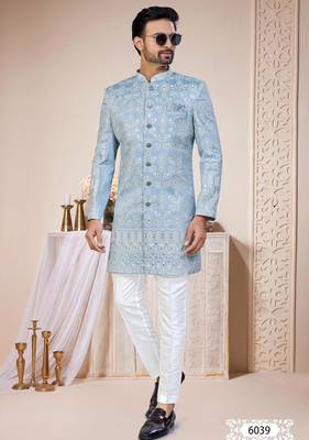 Light blue sherwani with white embroidery and mirror work, paired with white trousers—perfect for weddings. 1