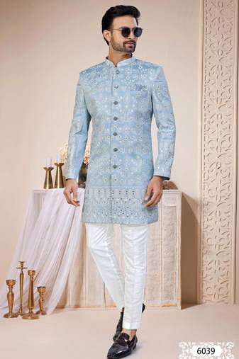 Light blue sherwani with white embroidery and mirror work, paired with white trousers   perfect for weddings.
