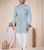 Light blue sherwani with white embroidery and mirror work, paired with white trousers—perfect for weddings.