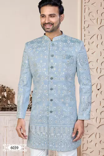 Light blue sherwani with white embroidery and mirror work, paired with white trousers—perfect for weddings.