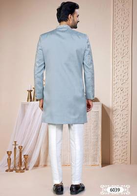 Light blue sherwani with white embroidery and mirror work, paired with white trousers—perfect for weddings. 4
