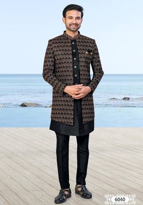 Black sherwani with copper-gold detailing and matching trousers—perfect for weddings and celebrations. 1
