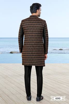 Black sherwani with copper-gold detailing and matching trousers—perfect for weddings and celebrations. 4