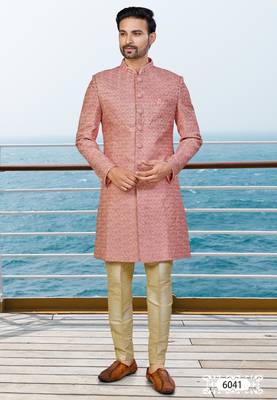 Peach sherwani with woven detailing and gold-toned trousers—perfect for weddings and celebrations. 1