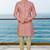 Peach sherwani with woven detailing and gold-toned trousers—perfect for weddings and celebrations.
