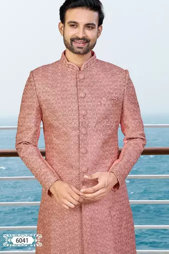 Peach sherwani with woven detailing and gold-toned trousers—perfect for weddings and celebrations.