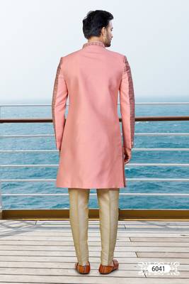 Peach sherwani with woven detailing and gold-toned trousers—perfect for weddings and celebrations. 4