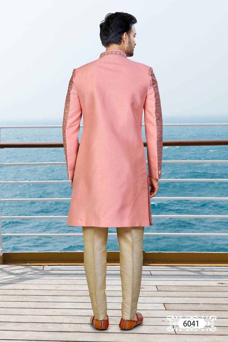 Peach sherwani with woven detailing and gold-toned trousers—perfect for weddings and celebrations.