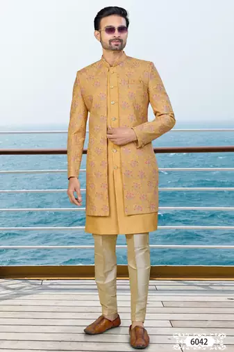 Mustard sherwani with pink and gold floral embroidery—perfect for festive weddings.