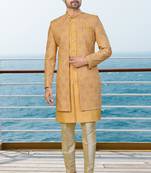 Mustard sherwani with pink and gold floral embroidery—perfect for festive weddings.