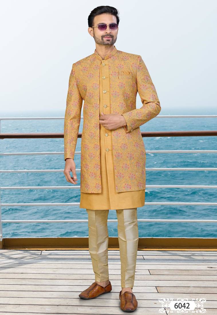 Mustard sherwani with pink and gold floral embroidery—perfect for festive weddings.