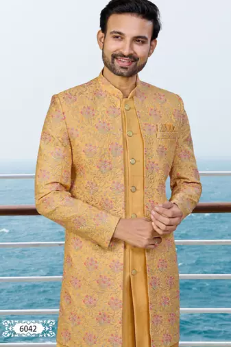 Mustard sherwani with pink and gold floral embroidery—perfect for festive weddings.