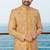 Mustard sherwani with pink and gold floral embroidery—perfect for festive weddings.