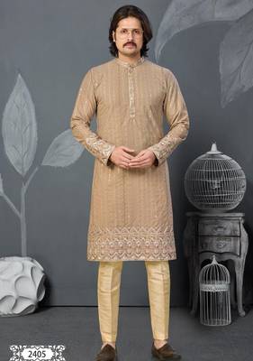Beige kurta with colorful embroidery and gold pajama—perfect for weddings and festive occasions. 1