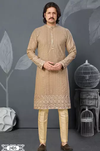 Beige kurta with colorful embroidery and gold pajama—perfect for weddings and festive occasions.