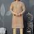 Beige kurta with colorful embroidery and gold pajama—perfect for weddings and festive occasions.