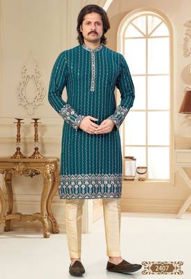 Teal blue embroidered kurta with cream pajama—perfect for festive occasions. 1