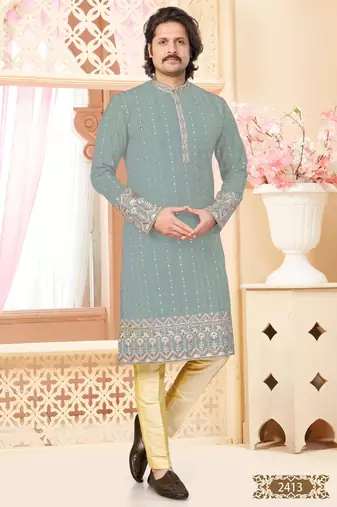 Sage green kurta with floral embroidery, paired with gold pajama—perfect for festive occasions.