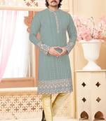 Sage green kurta with floral embroidery, paired with gold pajama—perfect for festive occasions.