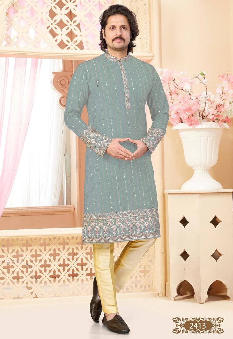 Sage green kurta with floral embroidery, paired with gold pajama—perfect for festive occasions.
