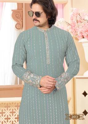 Sage green kurta with floral embroidery, paired with gold pajama—perfect for festive occasions. 3