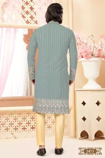 Sage green kurta with floral embroidery, paired with gold pajama—perfect for festive occasions.
