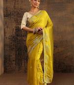 yellow ethnic motifs embellished tissue saree with unstitched blouse piece