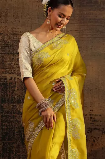 yellow ethnic motifs embellished tissue saree with unstitched blouse piece