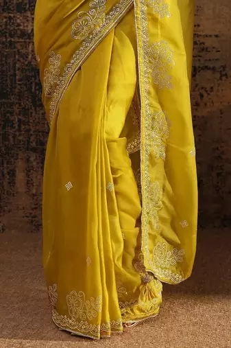 yellow ethnic motifs embellished tissue saree with unstitched blouse piece