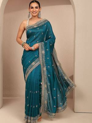 teal floral zari embroidered saree with zari embellished border and a blouse piece 1