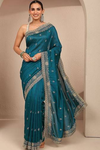 teal floral zari embroidered saree with zari embellished border and a blouse piece