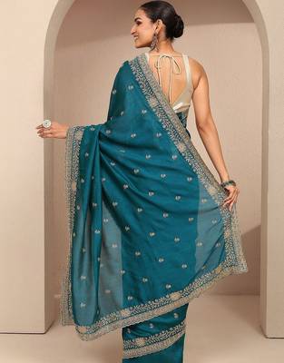 teal floral zari embroidered saree with zari embellished border and a blouse piece 3