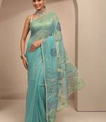 teal ethnic motif beads embellished saree with embellished border and a blouse piece