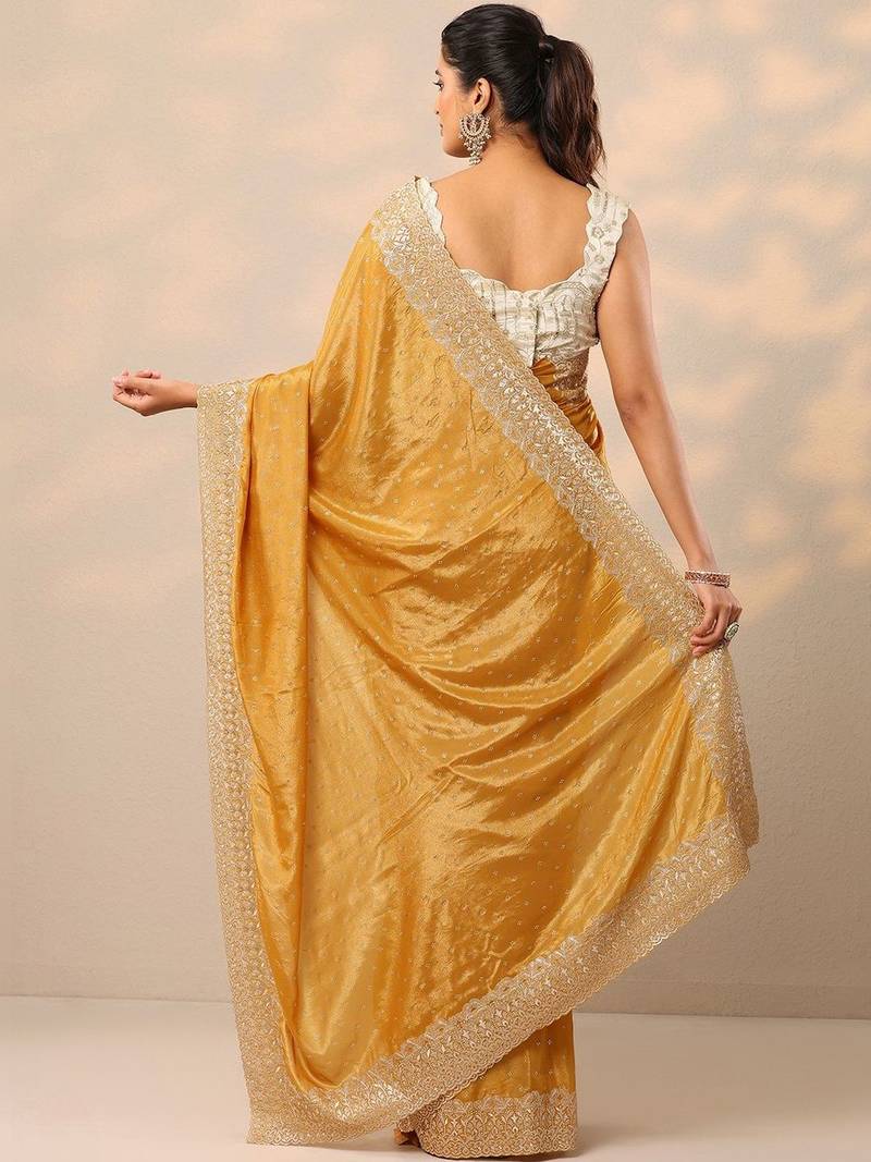 yellow embellished crepe sarees with unstitched blouse piece