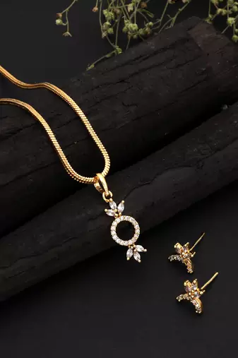 Radiant sheen gold color american diamond pendant set designed for evening celebrations
