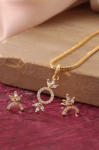 Radiant sheen gold color american diamond pendant set designed for evening celebrations