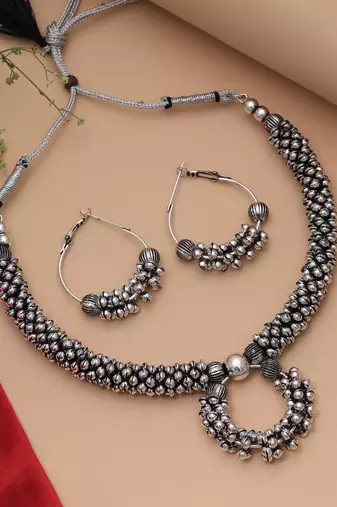 Graceful royal silver color oxidised necklace set styled for traditional saree pairing