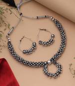 Graceful royal silver color oxidised necklace set styled for traditional saree pairing